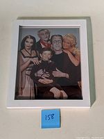 Full view of framed promotional photograph of The Munsters TV show cast featuring Butch Patrick.