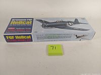 Sealed boxed model kit of Guillow's Grumman F6F Hellcat with label and wing span details visible.