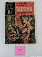 Front cover and full view of comic showing Tarzan with leopard on tree branch, price 25 cents.