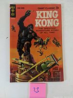 Full front cover of King Kong #1 comic book showing King Kong fighting biplanes with an orange background.