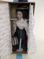 Front view of the Ashton Drake Gibson Girl doll in original box showing full doll with period costume and accessories.