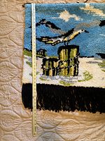 Full view of bottom left corner showing the seagull flying over yellow pilings and black fringe at bottom edge with measuring ruler to indicate size.