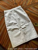 Back view of white leather skirt showing smooth back panel and natural creases.