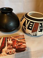 Two Hopi pottery vases, one blackware and one painted, with postcard.