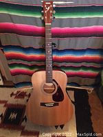 Full front view of Yamaha F370 NAT acoustic guitar showing natural wood finish, headstock with Yamaha logo, neck and body with pickguard.