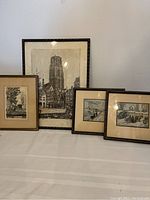 Four framed prints displayed together showing a large architectural black and white print, two smaller color prints, and one smaller black and white print.