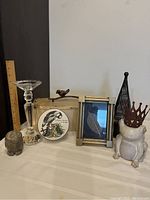 Full lot showing ceramic frog with metal crown, crystal owl candle holder, Villeroy & Boch dish with lid, decorative box with bird handle, gold leaf photo frame, and black metal candle holder.