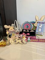 Photo showing the full lot with stuffed bunny, wicker basket, wooden signs, Easter eggs in boxes, hanging ornaments, and crafts.