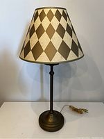 Full view of the lamp showing cast iron base and patterned shade
