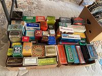 Full view of collection with various Avon aftershave decanter boxes in cardboard trays.