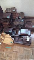 Overview of multiple wooden jewelry and music boxes, showing variety in size and style, including stacked boxes and flat boxes with compartments.