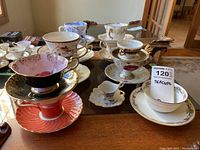 Six assorted teacup and saucer sets displayed front and center