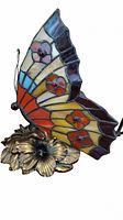 Side view showing colorful stained glass butterfly wing and metallic floral base