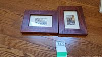 Two framed miniature prints with wooden frames on a wooden floor.
