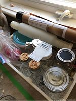 Photo of glass jars, rolling pin, baking mat, and spatula packed in a tray
