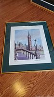 Framed print showing the Parliament Buildings with signature and numbering visible.