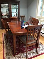 Dining table and chairs from front angle showing table top and chairs