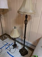 Full view of floor lamp and table lamp side by side showing metal bases with granite inserts and fabric shades.