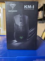 Front view of the box showing the image of the Bengoo KM-1 wireless gaming mouse in black with the brand logo and model name.