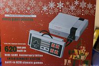 Front of box showing console and controller image with text indicating 620 classic built-in games and plug and play functionality.