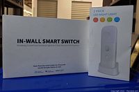 Photo of the box for in-wall smart switches and 2-pack LED night light packaging showing product type and compatibility.