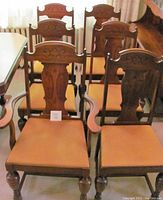Set of six dining chairs arranged in two rows showing backs and seats, includes one chair with arms (Captain's chair) and five side chairs.