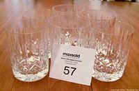 Six clear lead crystal bourbon or whisky glasses arranged in two rows on a wooden surface with a lot number card in front.