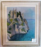 Framed oil painting showing castle on cliff by the sea