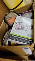 Box showing multiple baseball caps inside and a visible label for the baseball cap storage bag.