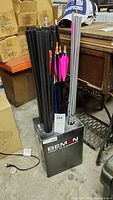 Full set of arrows vertically placed in Beman branded holder showing colors and condition.
