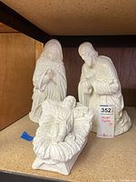 Front view showing Mary, Joseph, and baby Jesus in the manger white ceramic figures.