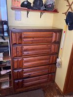 Full front view of the vintage wood tall boy dresser showing five drawers with unique ridged design.
