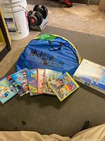 Hide and Side play tunnel with assorted kids DVDs in front