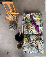 Photo showing the various garden and lawn items including chair, watering can, pots, gloves, umbrellas, cushions, garden tools, mesh roll, and soil bag