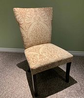 Front and side angle view showing the upholstery pattern, chair design, and legs.