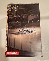 Full front cover of the 1999 Toronto Maple Leafs official NHL calendar showing players on the ice in Maple Leaf Gardens with Shoppers Drug Mart logo and two circular logos