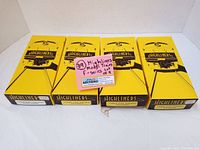 Four yellow boxes of Highliners model train kits featuring front locomotive illustration with model numbers on sides.