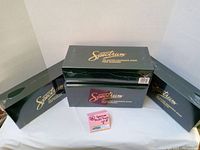 Four dark green boxes marked Spectrum Master Railroader Series containing model train cars, arranged on a white cloth.