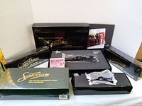 Five original Spectrum boxes containing one locomotive and four coach cars in original packaging