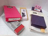Four HO scale train model kits in original vintage packaging including a red box for the 70 Ton Enterprise Covered Hopper and other boxed kits.