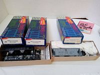 Three boxed Roundhouse HO scale covered hopper kits, two black unlettered (#1430) and one grey Pennsylvania (#1431). Boxes and contents shown.