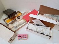 Photo of five new old stock boxed HO scale and On3 scale train car kits from brands including Yankee Clipper Models and Golden Spike, showing unopened boxes and partial packaging details.