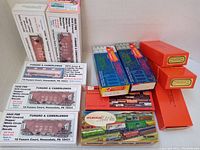 Overall photo of sealed boxes containing HO scale model freight train kits from Funaro & Camerlengo, Ulrich, Roundhouse, and other brands.