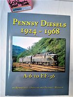 Front cover of the coffee table book Pennsy Diesels 1924-1968 A-6 to EF-36 showing diesel locomotives on a scenic railroad track.