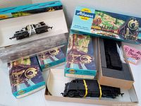 Top view of 4 boxed vintage Athearn HO scale train kits showing one black locomotive and colorful original packaging.
