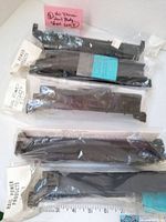 Five black HO scale train body shells and packaging shown from above. Visible model names and company labels.