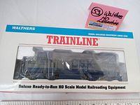 Front view of the Walthers Trainline GP-15 HO scale locomotive model in original box with clear window showing blue CSXT 1523 locomotive.