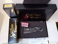 Four black Spectrum boxes arranged with foam insert revealing Shay locomotive and instruction sheet