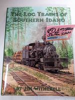 Front cover of 'The Log Trains of Southern Idaho' book by Jim Witherell, showing locomotive artwork.