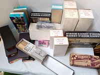 Photo showing multiple boxed HO scale model train kits and diesel body kits including Arbour Models and Roundhouse Products boxes, and boxed plastic parts for HO train assembly.